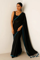 SERENITY BREEZE | Mul Cotton | Indidha Saree -  Serenity Breeze – Black Mul Cotton Saree | Indidha  Shop Serenity Breeze, a handcrafted black mul cotton saree with blue edging & tassels. Lightweight, breathable, and effortlessly elegant. Only at Indidha.