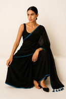 SERENITY BREEZE | Mul Cotton | Indidha Saree -  Serenity Breeze – Black Mul Cotton Saree | Indidha  Shop Serenity Breeze, a handcrafted black mul cotton saree with blue edging & tassels. Lightweight, breathable, and effortlessly elegant. Only at Indidha.