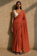 Ember Drape | Handloom Mul Cotton | Indidha Saree -  Ember Drape – Terracotta Red Handloom Mul Cotton Saree with Tassels | Indidha  Discover Ember Drape, a handloom mul cotton saree in terracotta red with white tassels. Ultra-soft, breathable, and elegant. No blouse included. Color may slightly vary due to screen settings.