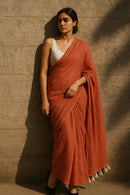 Ember Drape | Handloom Mul Cotton | Indidha Saree -  Ember Drape – Terracotta Red Handloom Mul Cotton Saree with Tassels | Indidha  Discover Ember Drape, a handloom mul cotton saree in terracotta red with white tassels. Ultra-soft, breathable, and elegant. No blouse included. Color may slightly vary due to screen settings.