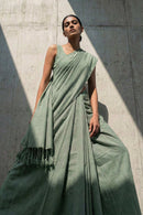 Elegant green slub cotton saree with refined drape and minimal design