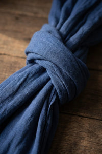 Blue fabric tied in a knot on a wooden surface